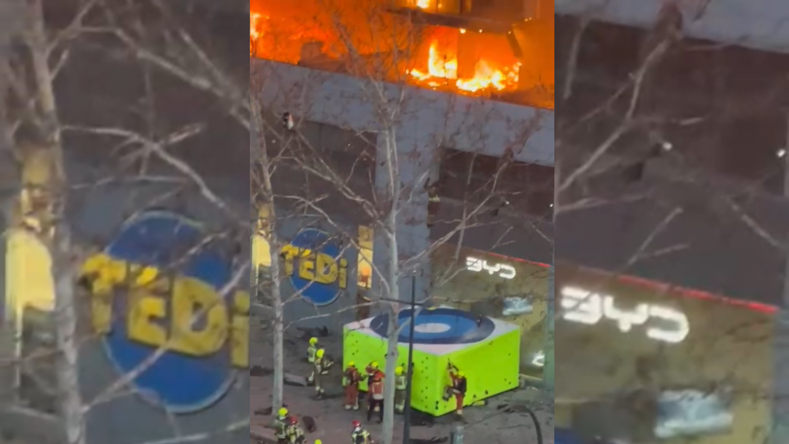 Un bomber bota des de l'edifici en flames