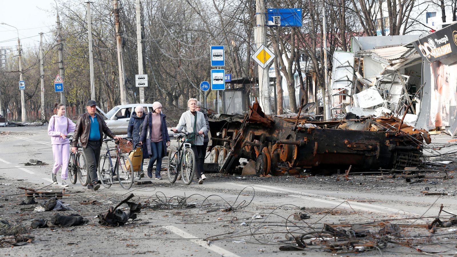 La gent passa al costat d'un tanc destruït en Mariupol, Ucraïna