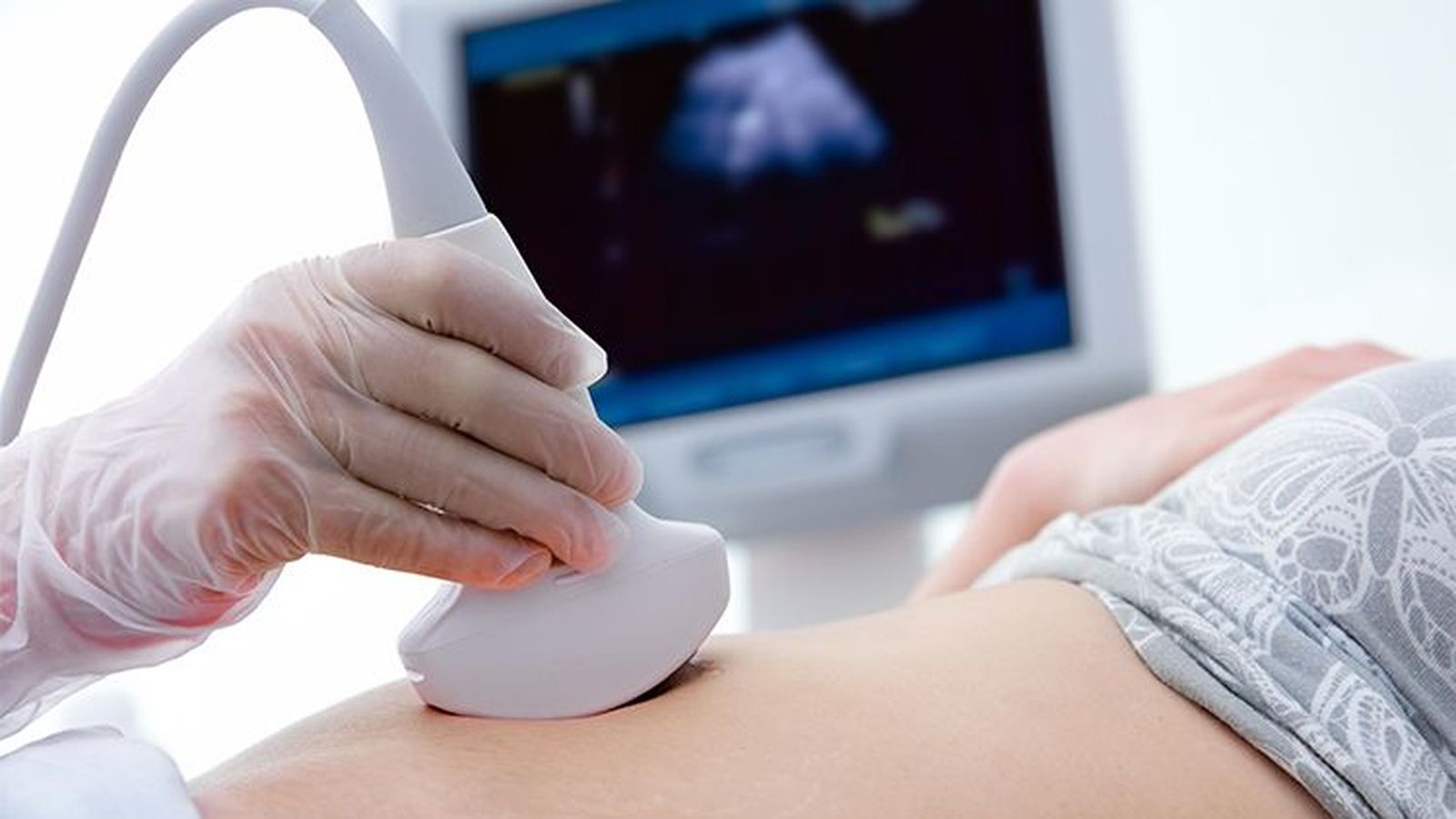 Metge que realitza un examen ecogràfic de la dona en la clínica