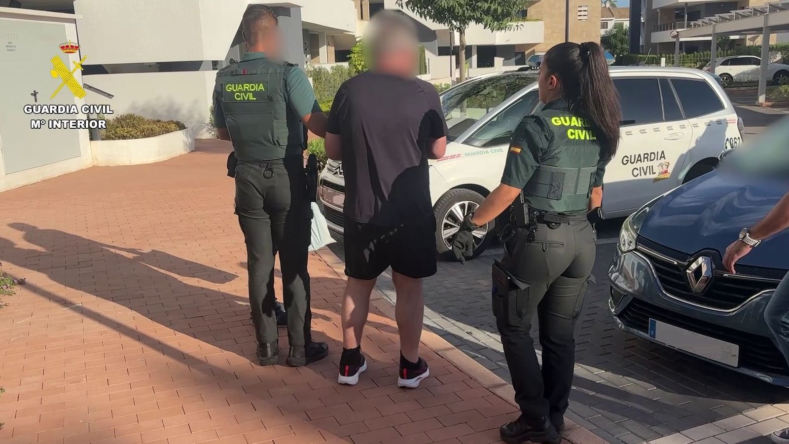 El fugitiu britànic detingut, custodiat per dos agents de la Guàrdia Civil