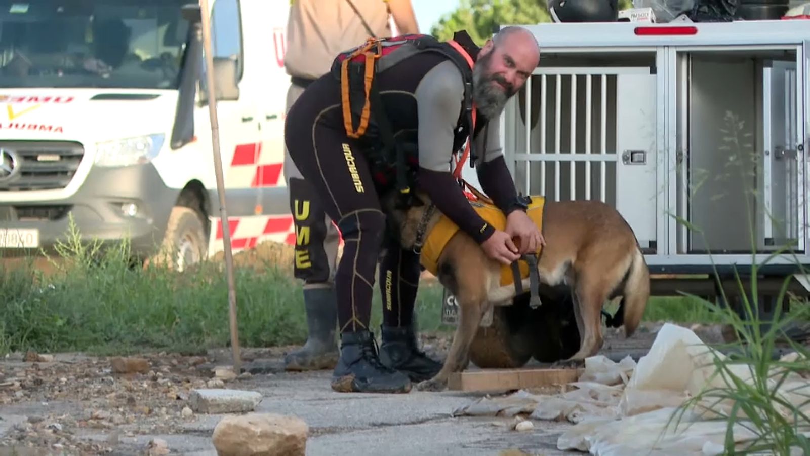 Un efectiu prepara un dels gossos que participen en la cerca del ciclista