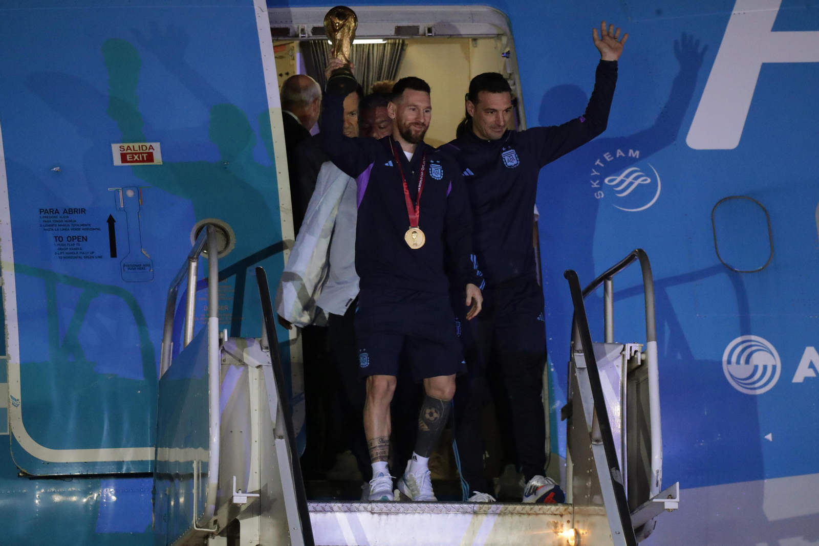 Messi baixa de l'avió amb la copa del món acompanyat de Scaloni