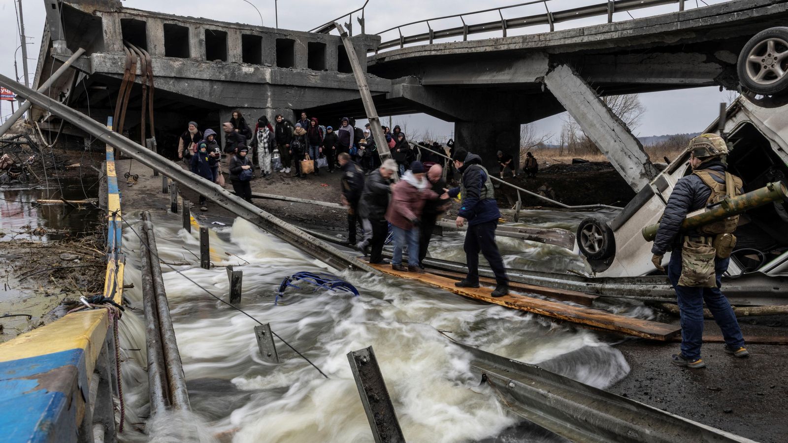 Residents d'Irpín creuen un pont totalment destrossat per a fugir de la ciutat