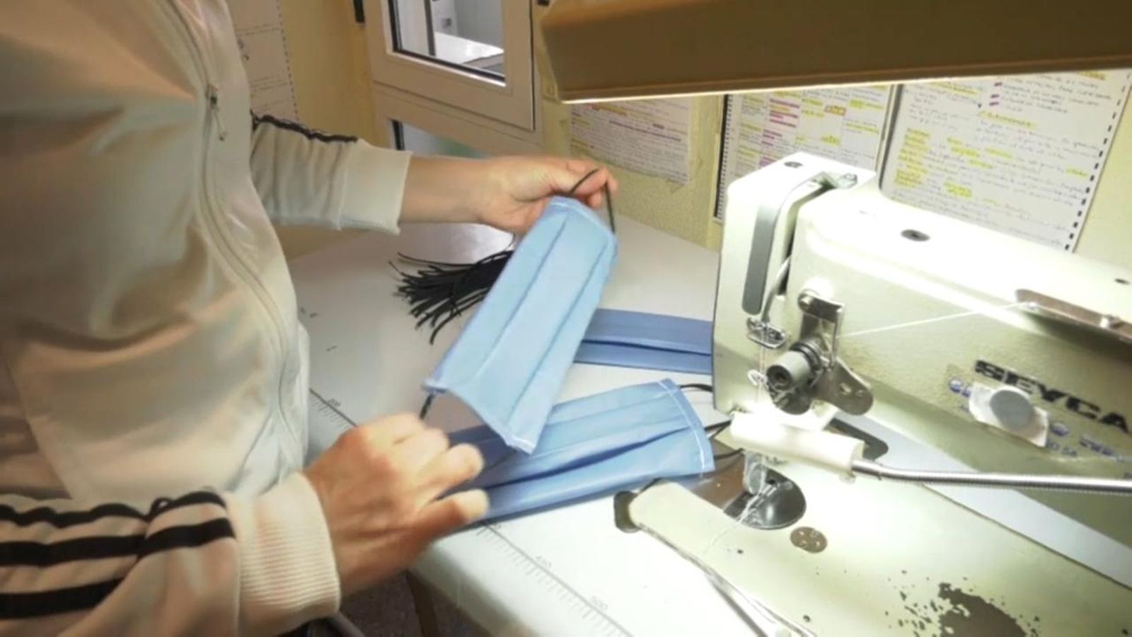 Una aparadora confecciona una mascareta