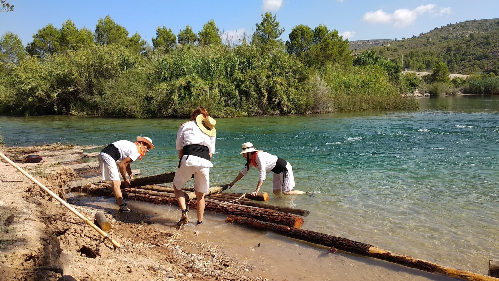 Diversos maeros preparen una de les 'navates' per a descendir pel Xúquer al terme de Sumacàrcer