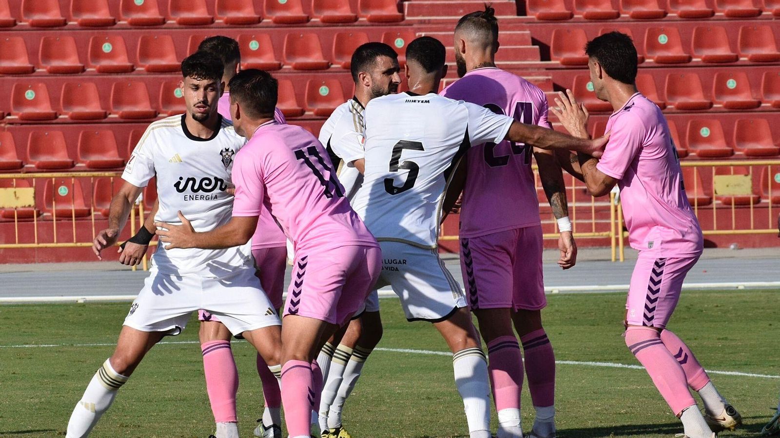 Jugadors d'un i altre equip, en una acció del partit