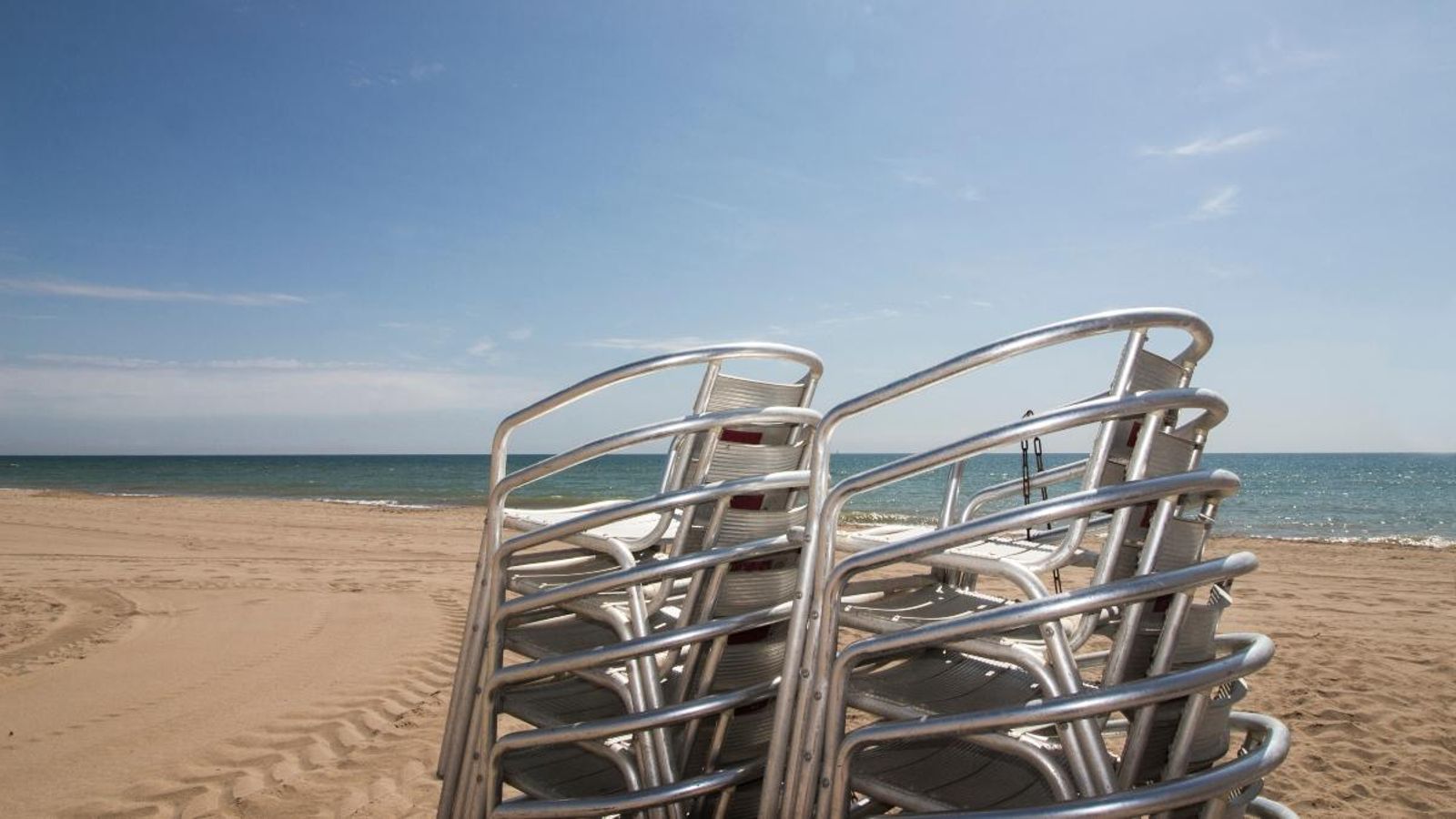 Cadires d'un restaurant apilades a una platja