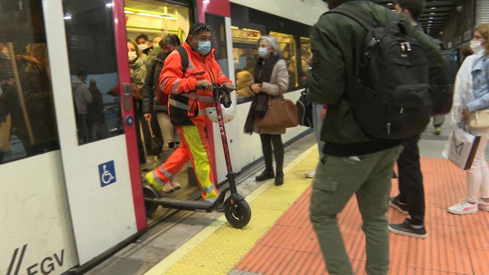 Un home ix del metro amb el seu patinet