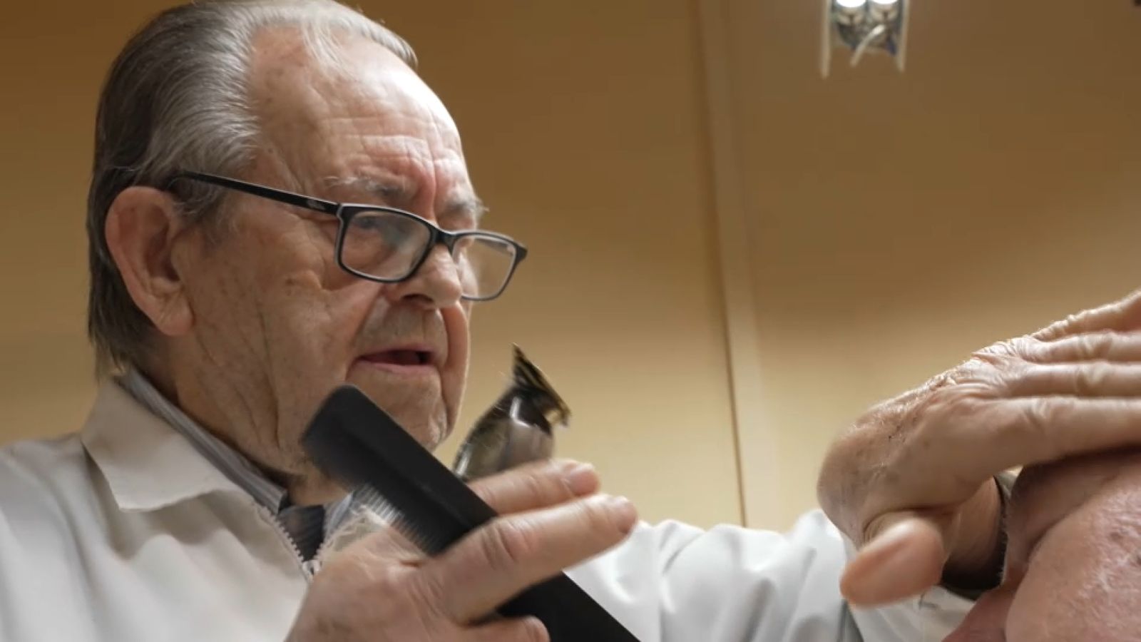 Enrique treballant en la seua perruqueria de Vinalesa, a l'Horta Nord