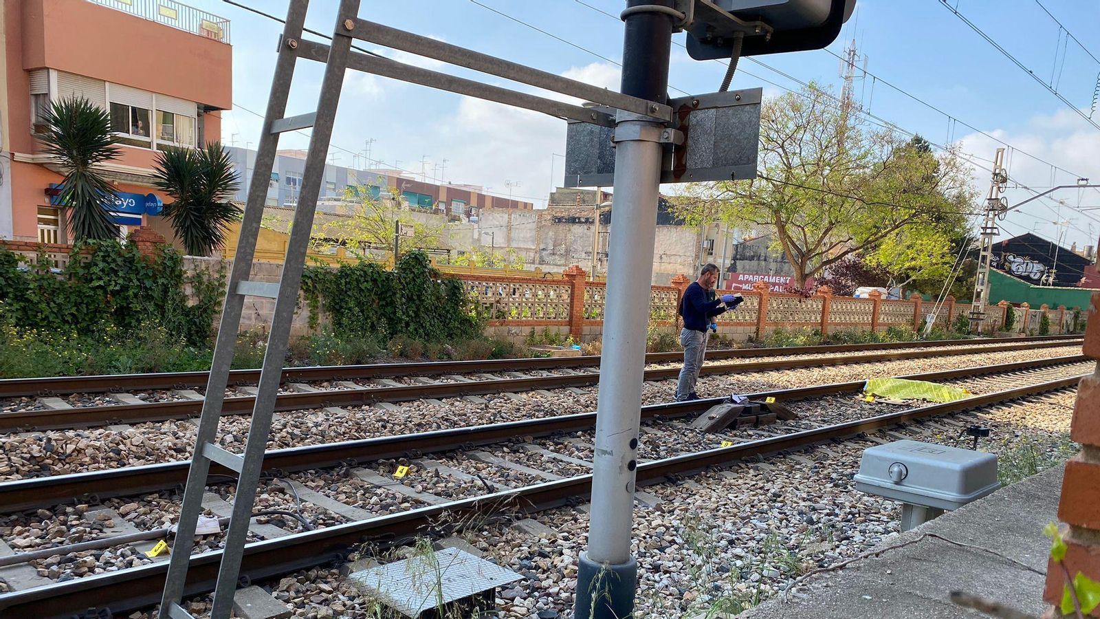 Un agent de la investigació junt al cos de la jove, que ha quedat enmig de les vies després de l'atropellament