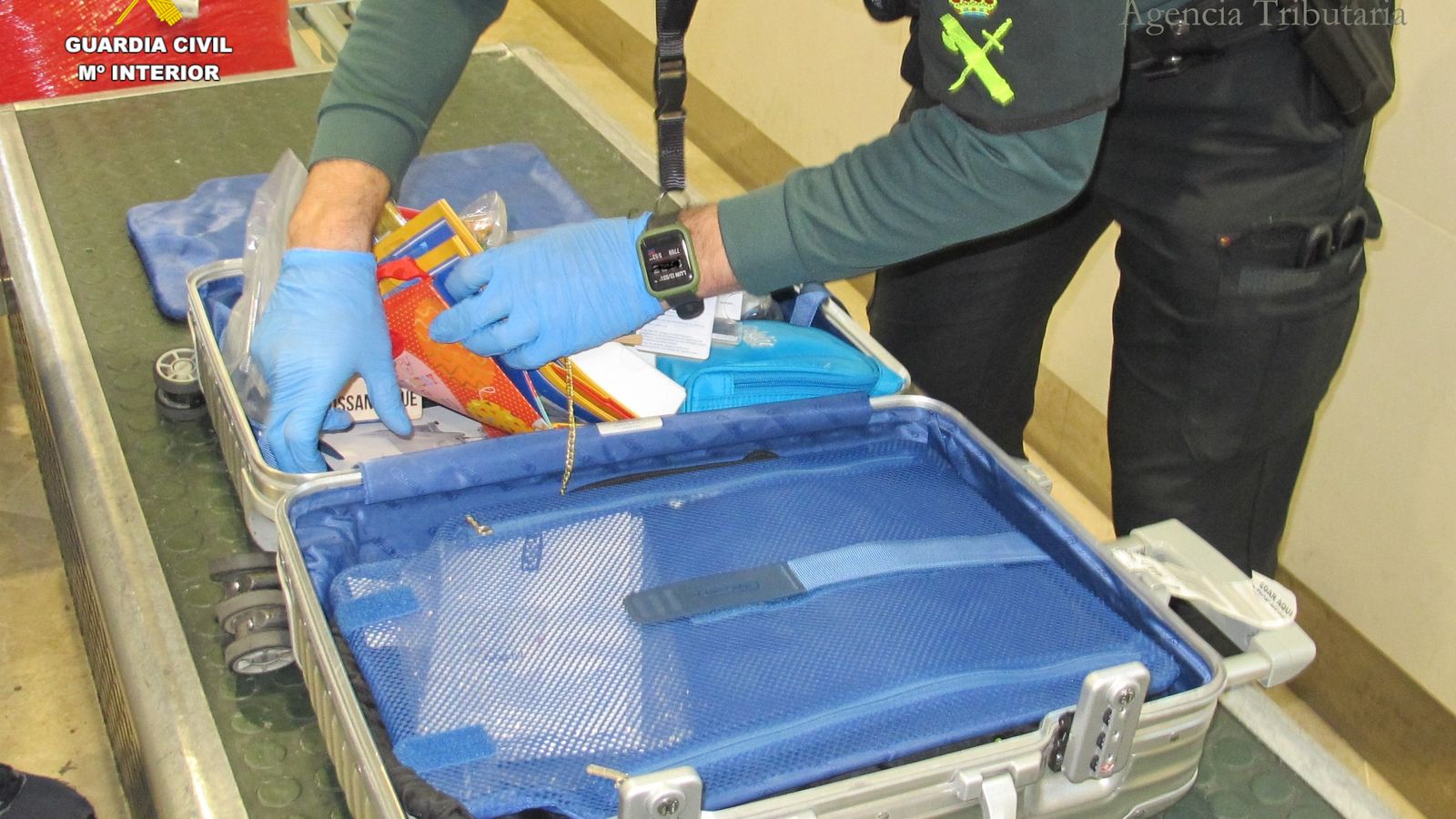 Un policia registra una maleta