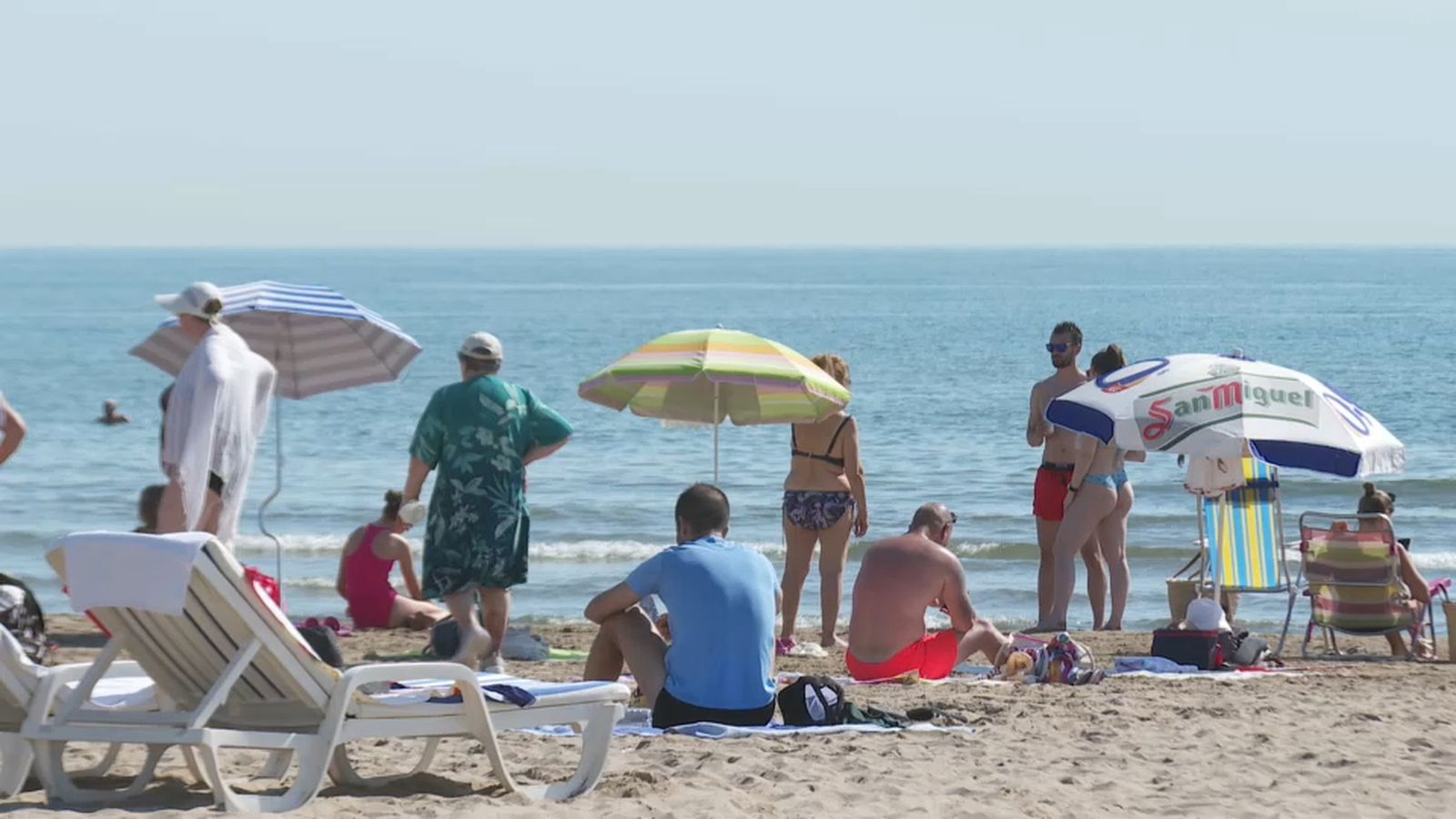 Un grup de turistes descansa en una platja a la Comunitat Valenciana