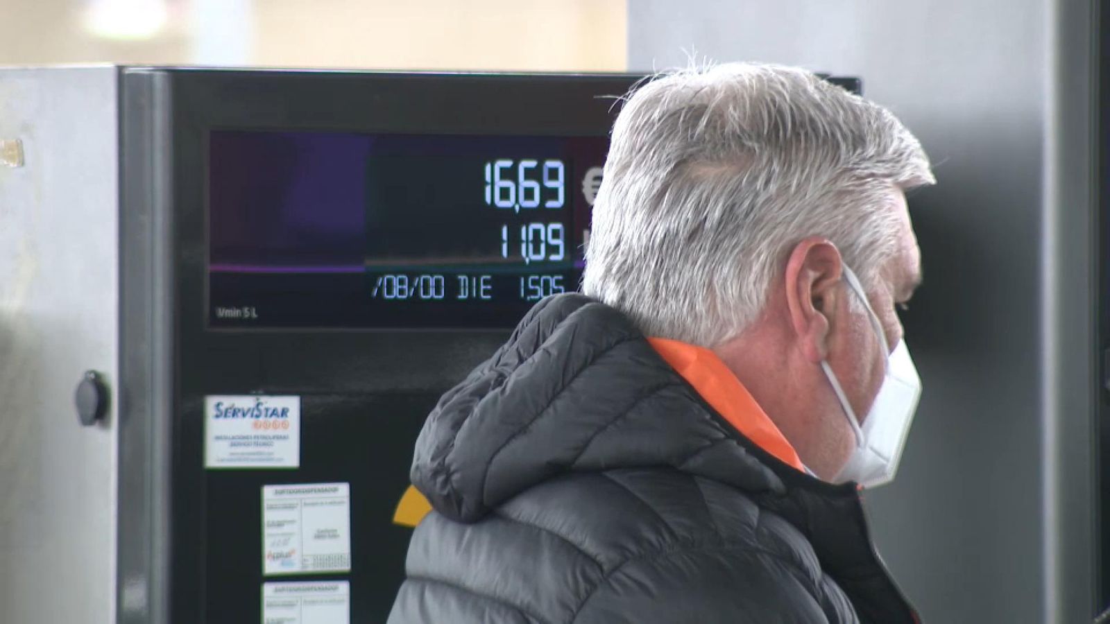 Un home reposta en una gasolinera