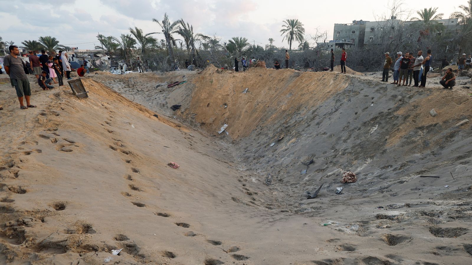Supervivents de l'atac contemplen el cràter que ha deixat el bombardeig