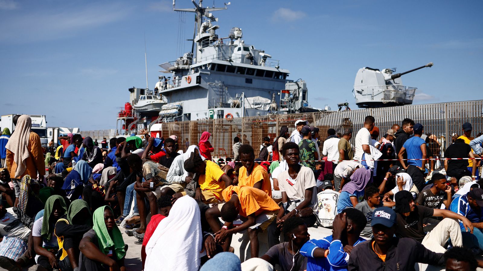 Migrants esperen en el port de Lampedusa