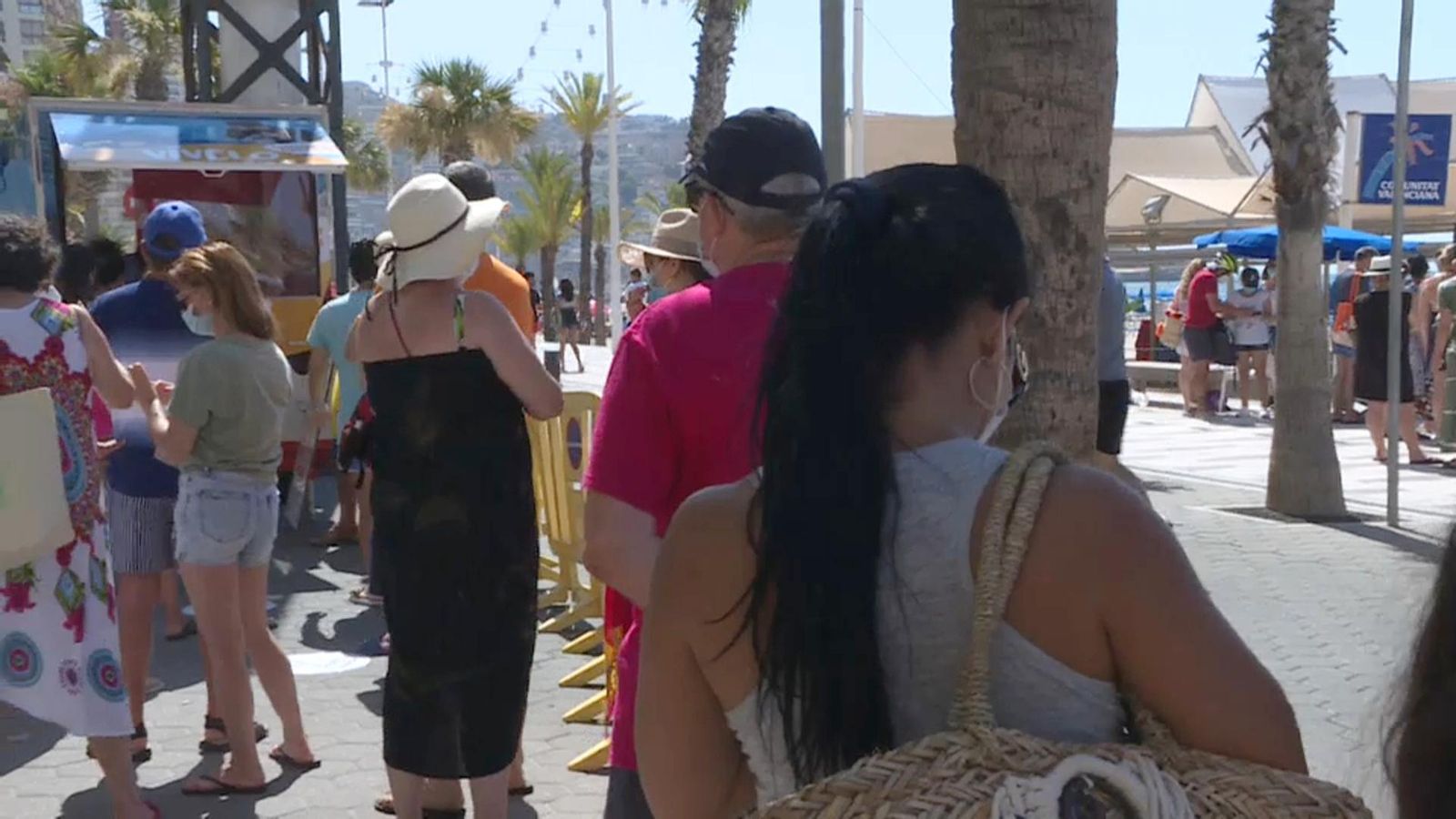 Els banyistes fan cua al punt d'informació habilitat per a la reserva de parcel·les de la platja de Llevant de Benidorm