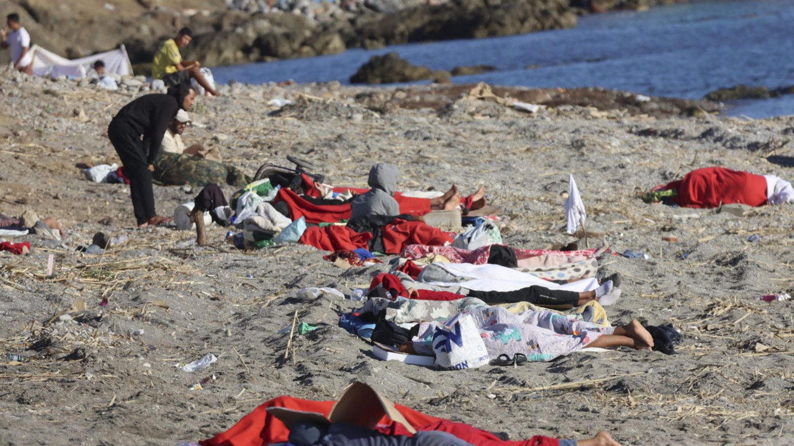 Alguns migrants a la platja del Trampolín de Ceuta