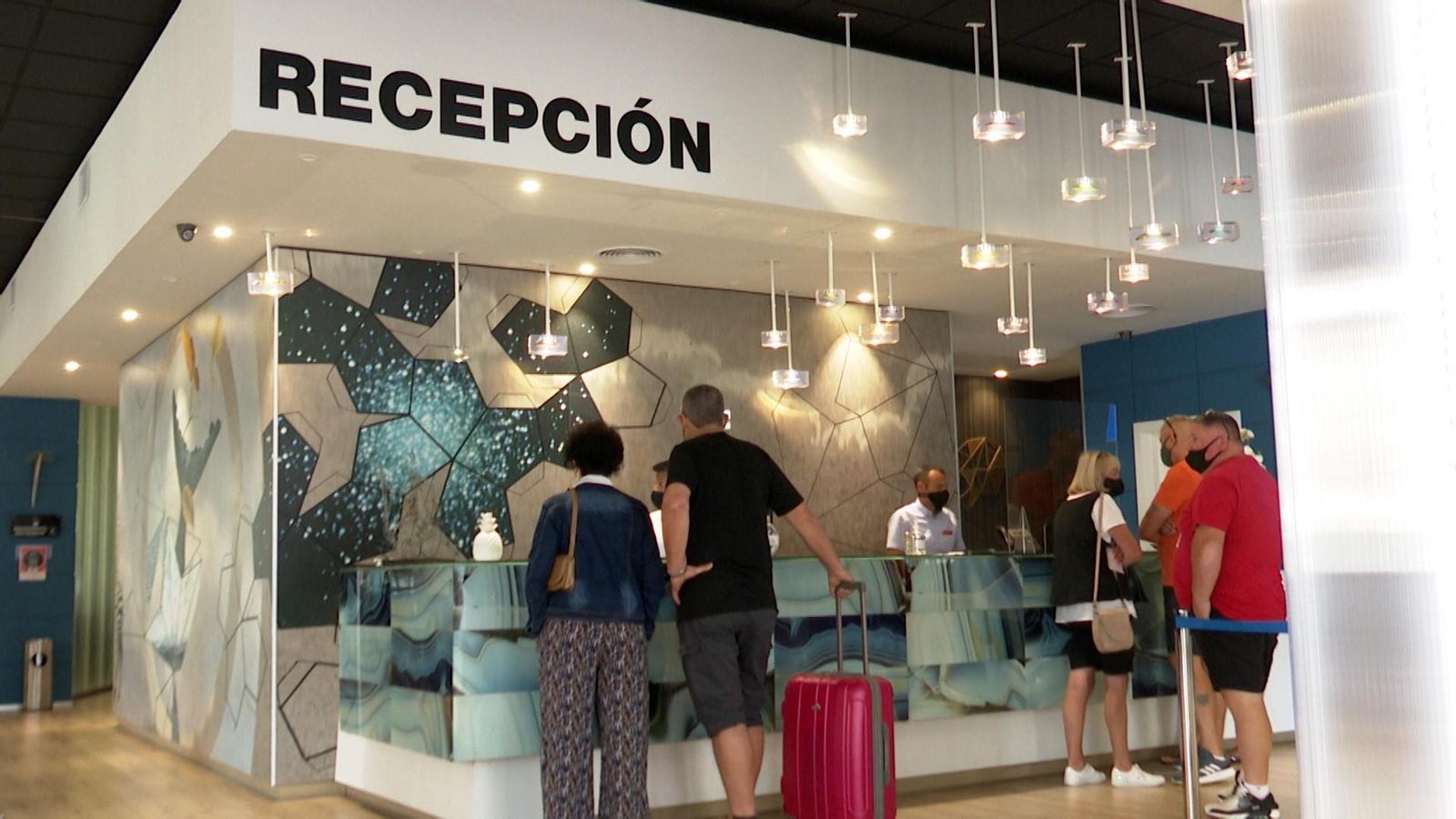 Turistes en la recepció d'un hotel
