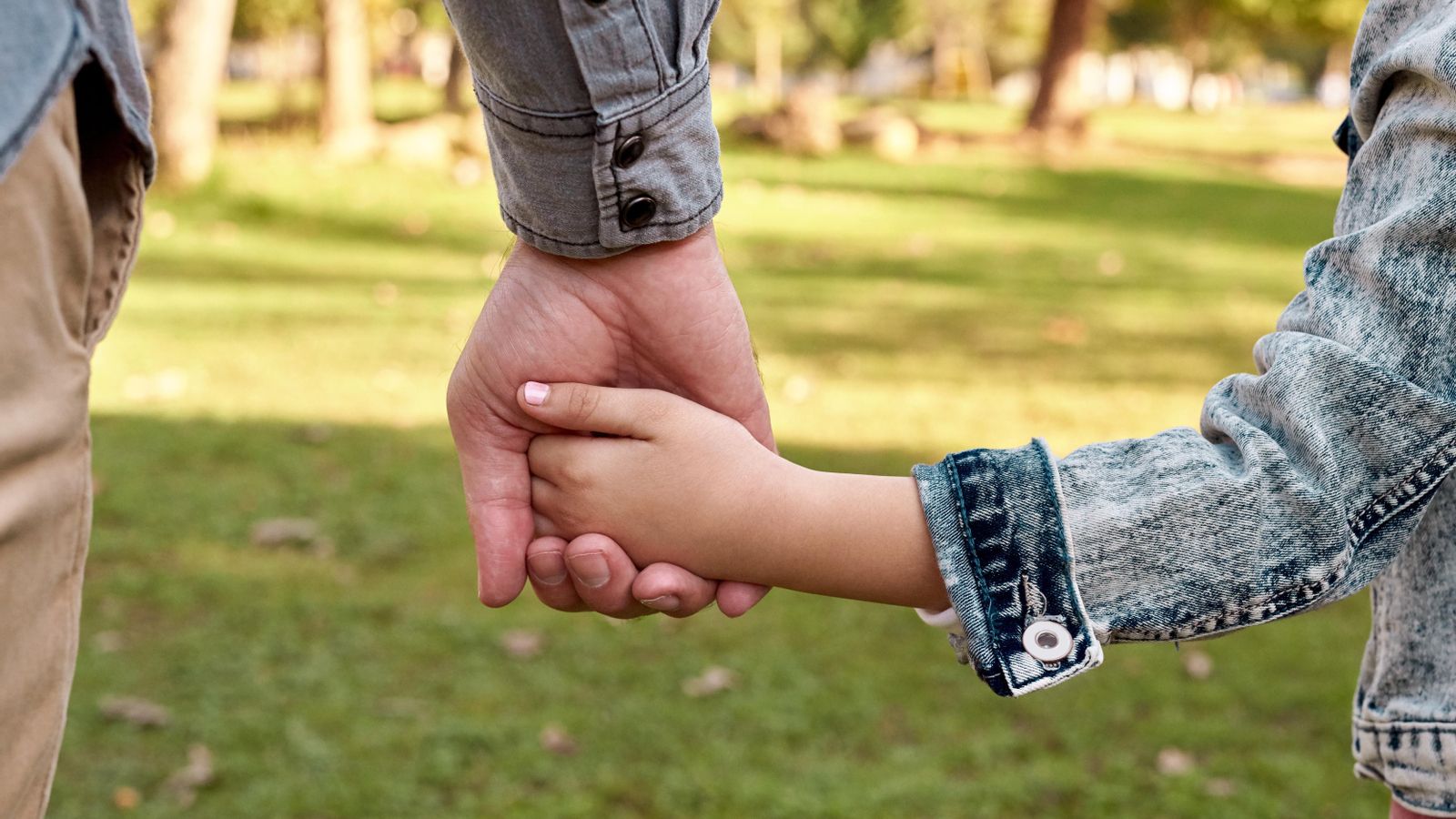 Un home porta un menor de la má