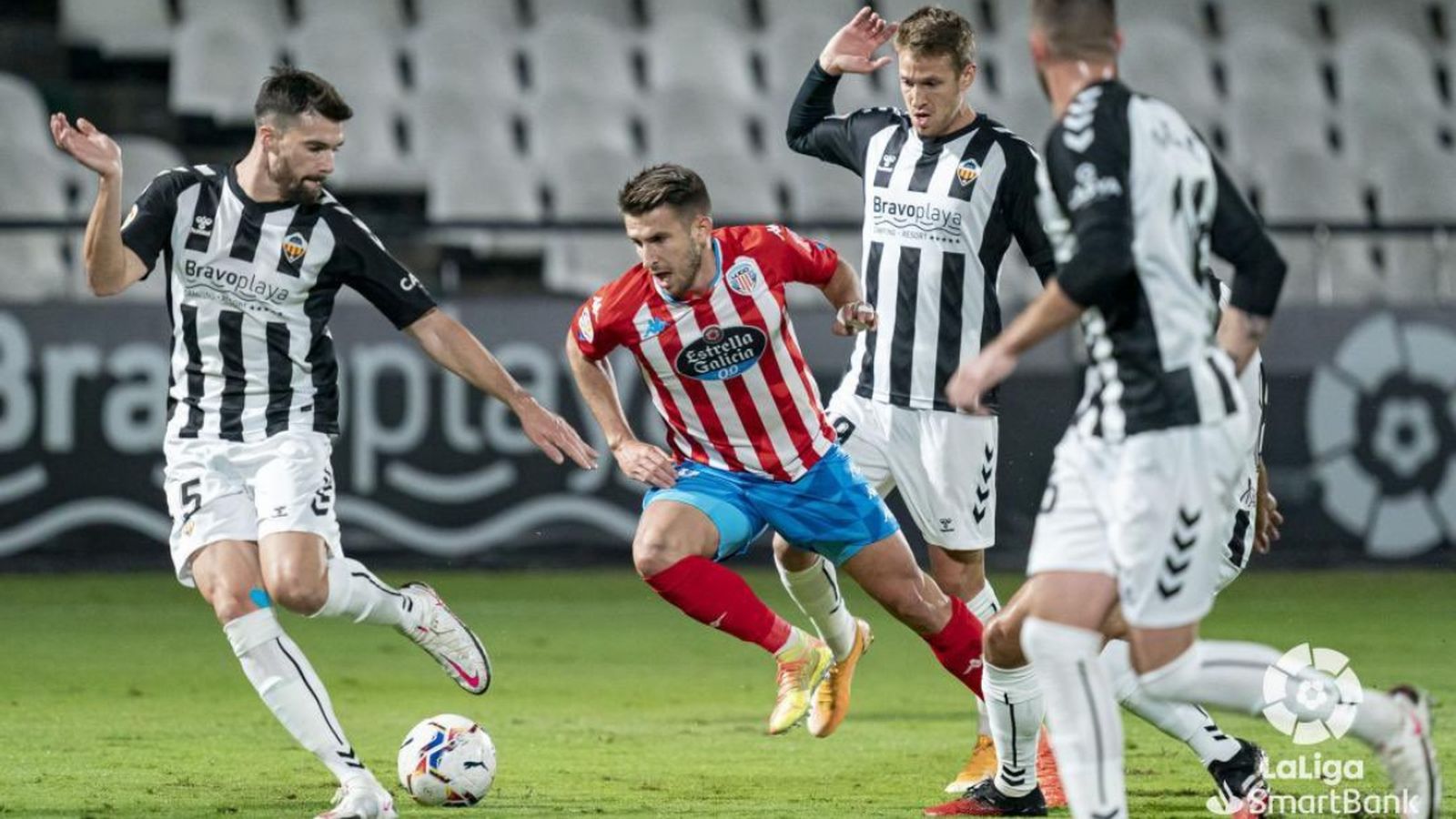 Tres jugadors del Castelló tracten de robar-li la pilota a un del Lugo