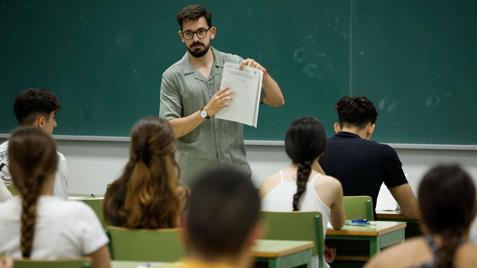 Un professor explica els apartats de l'examen a l'alumnat, ja disposat en l'aula, per a fer la primera prova de la PAU d'este dimarts