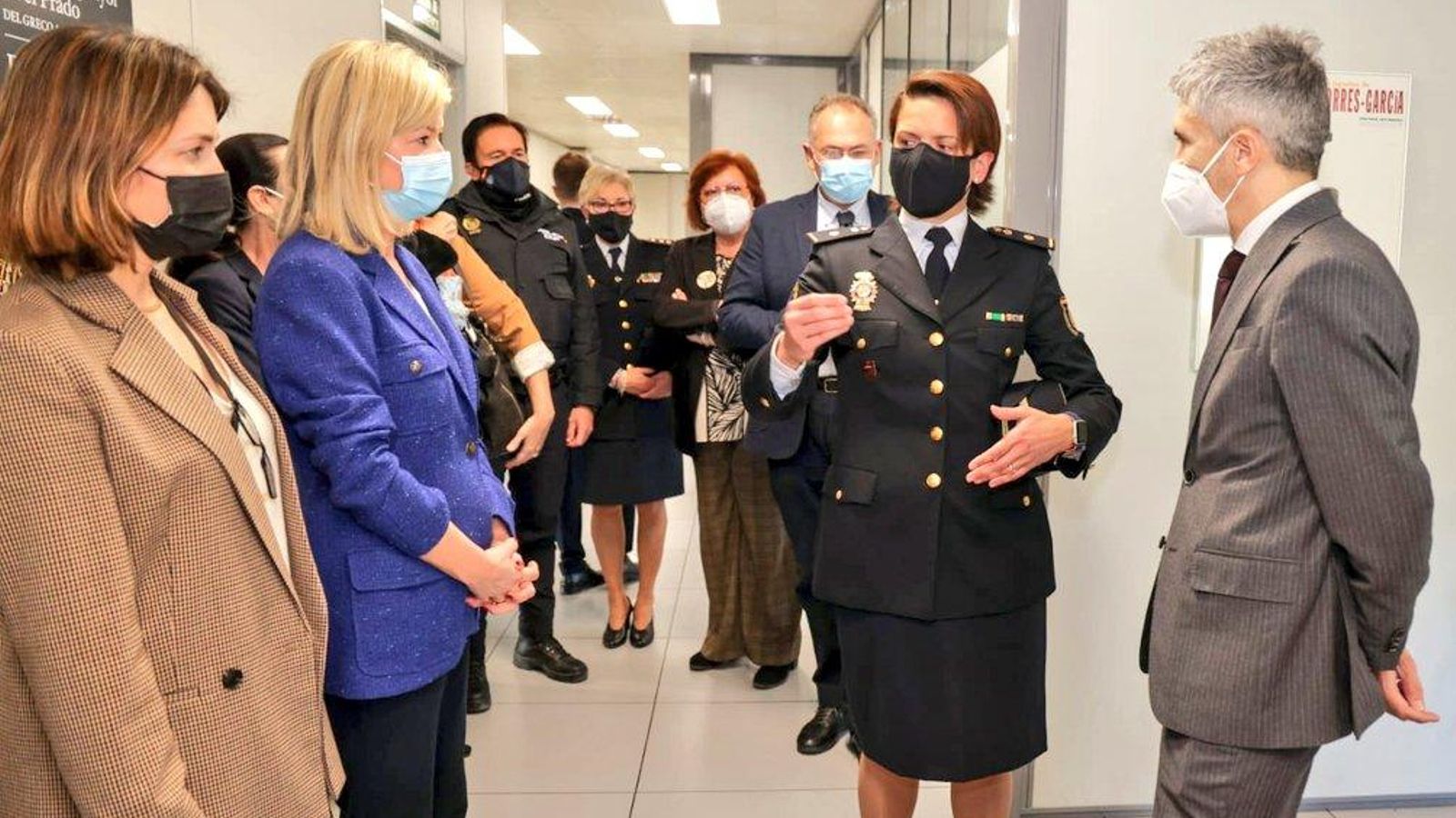 El ministre de l'Interior, a l'esquerra, conversa amb una agent de la policia de l'oficina que atén les víctimes de la violència masclista, en presència de la consellera de Justícia