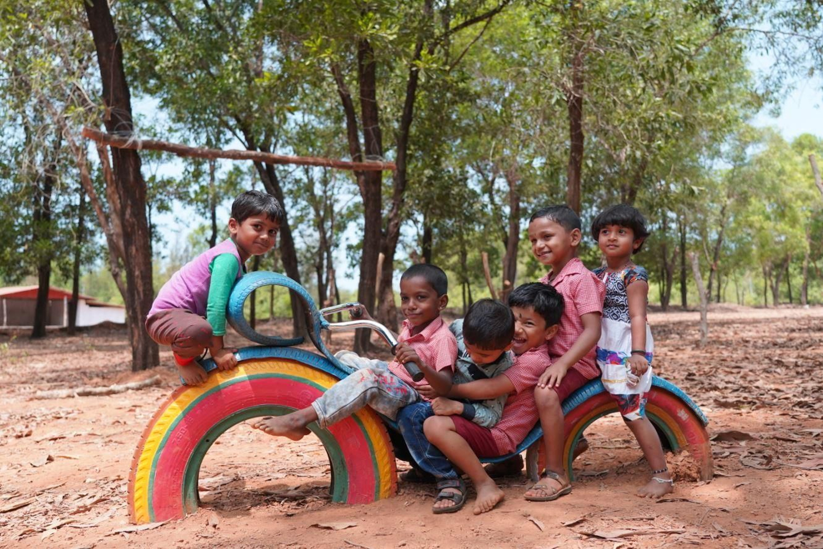 Alumnat de l'aldea de Heranjal juguen amb un dels jocs infantils ideats amb pneumàtics per l'enginyera Teresa Soriano