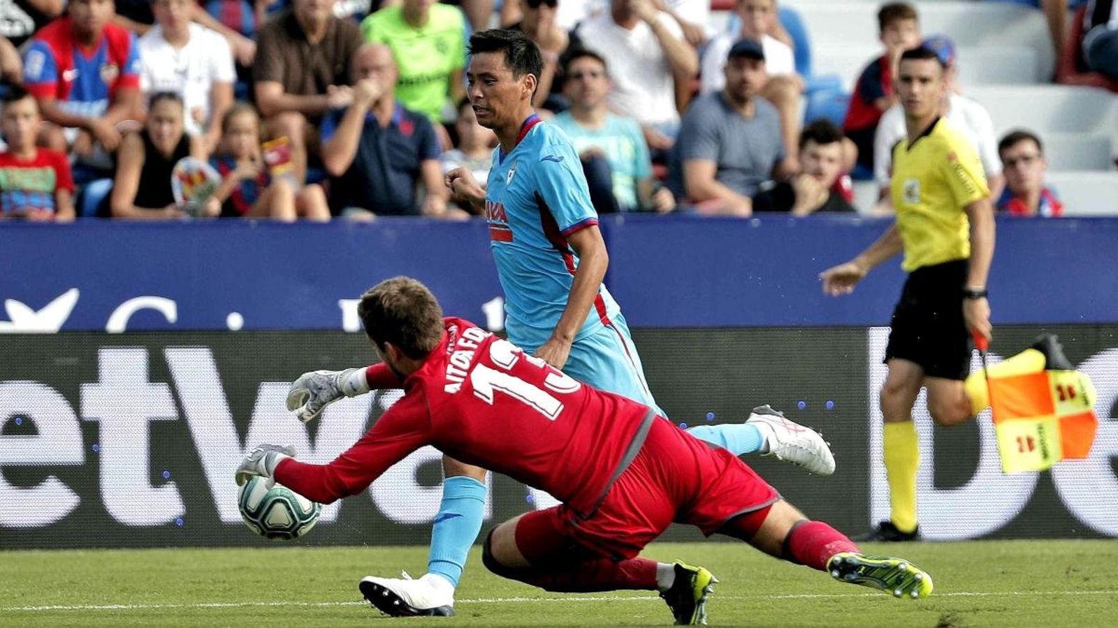 El jugador de l'SD Eibar, Takashi Inui, disputa un baló amb el porter del Llevant, Aitor Fernández