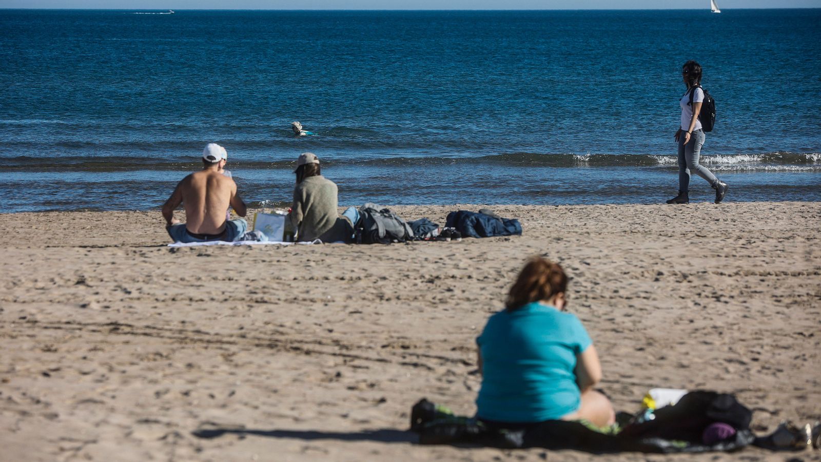 Diverses persones gaudeixen de les altes temperatures a la platja