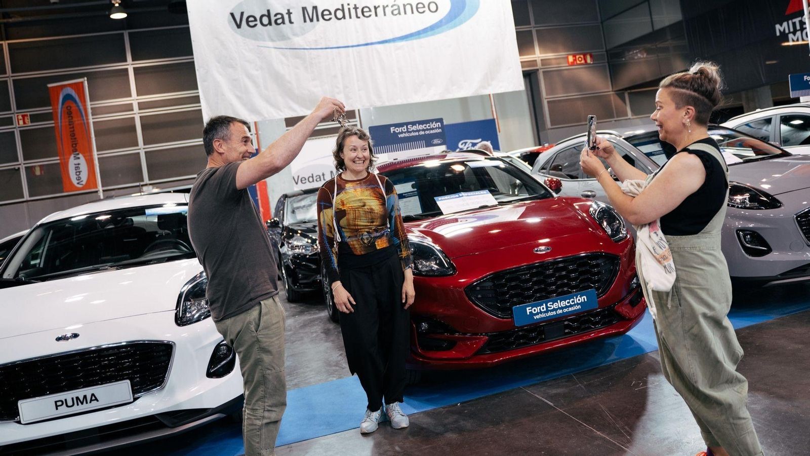 Una família compra un cotxe en la Fira de l'Automòbil Selecció Ocasió que se celebra este cap de setmana en Fira València.