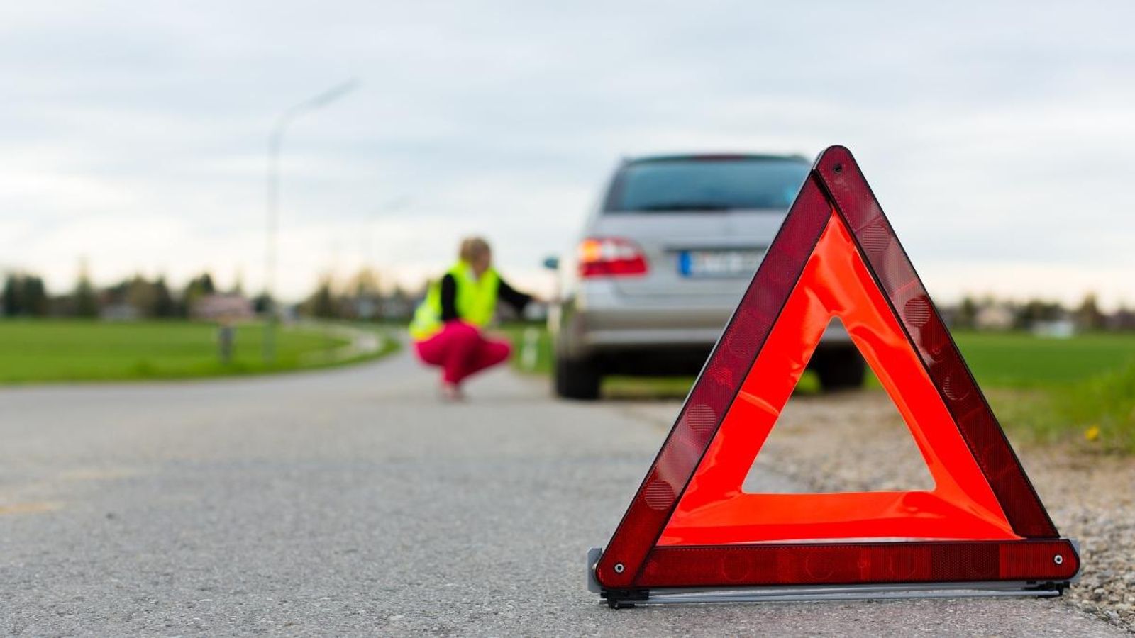 Un triangle, dels que actualment són obligatoris, adverteix d'un vehicle avariat al voral de la carretera