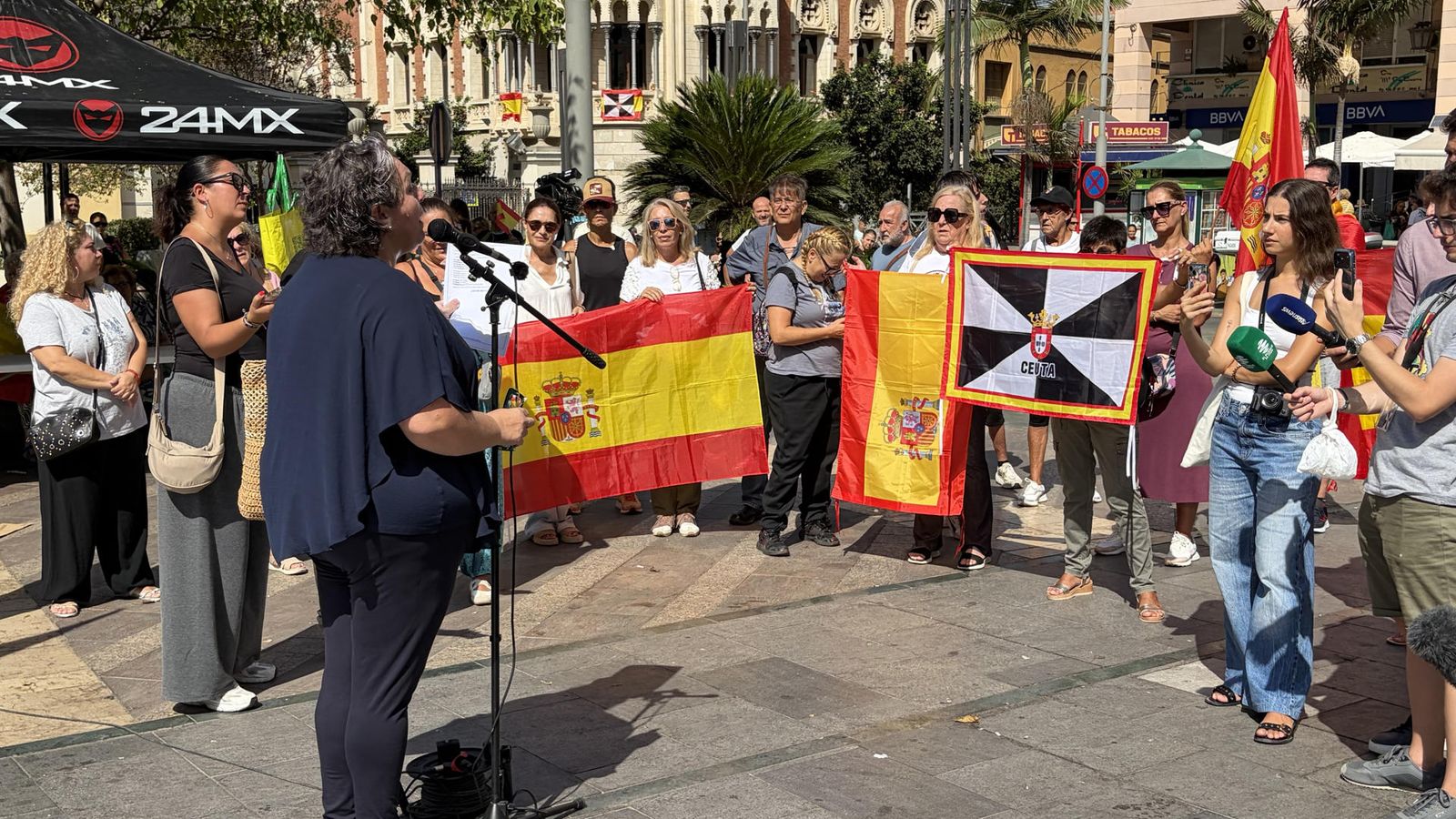 Representants del Fòrum Ciutadà d'Ajuda a Ceuta davant de desenes de persones en la mobilització d'este dissabte al migdia