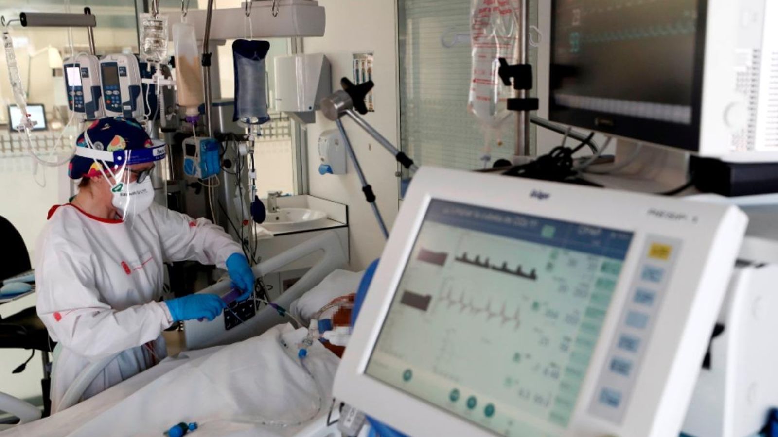 Una infermera de l'UCI del Complex Hospitalari de Navarra atén un pacient ingressat en la Unitat de Vigilància intensiva.