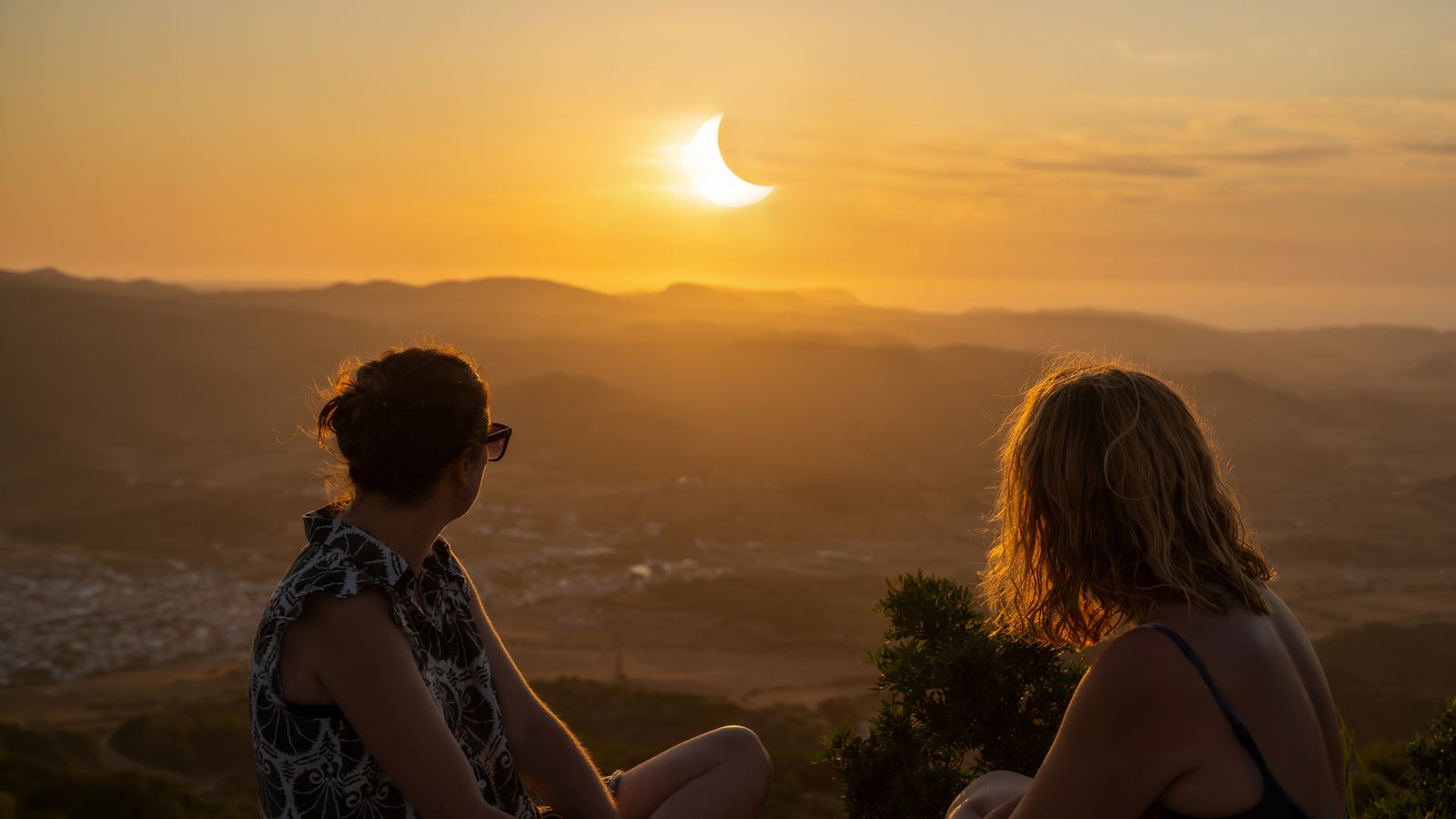 Imatge d'arxiu de dos amigues contemplant un eclipsi