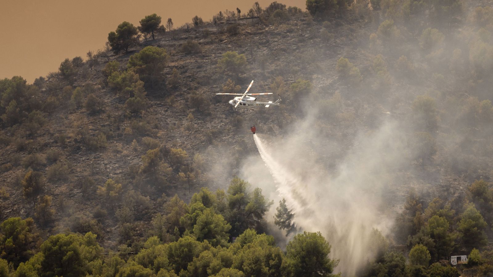 Un helicòpter durant les tasques d'extinció de l'incendi forestal, a 26 de juliol del 2026, a Betxí.