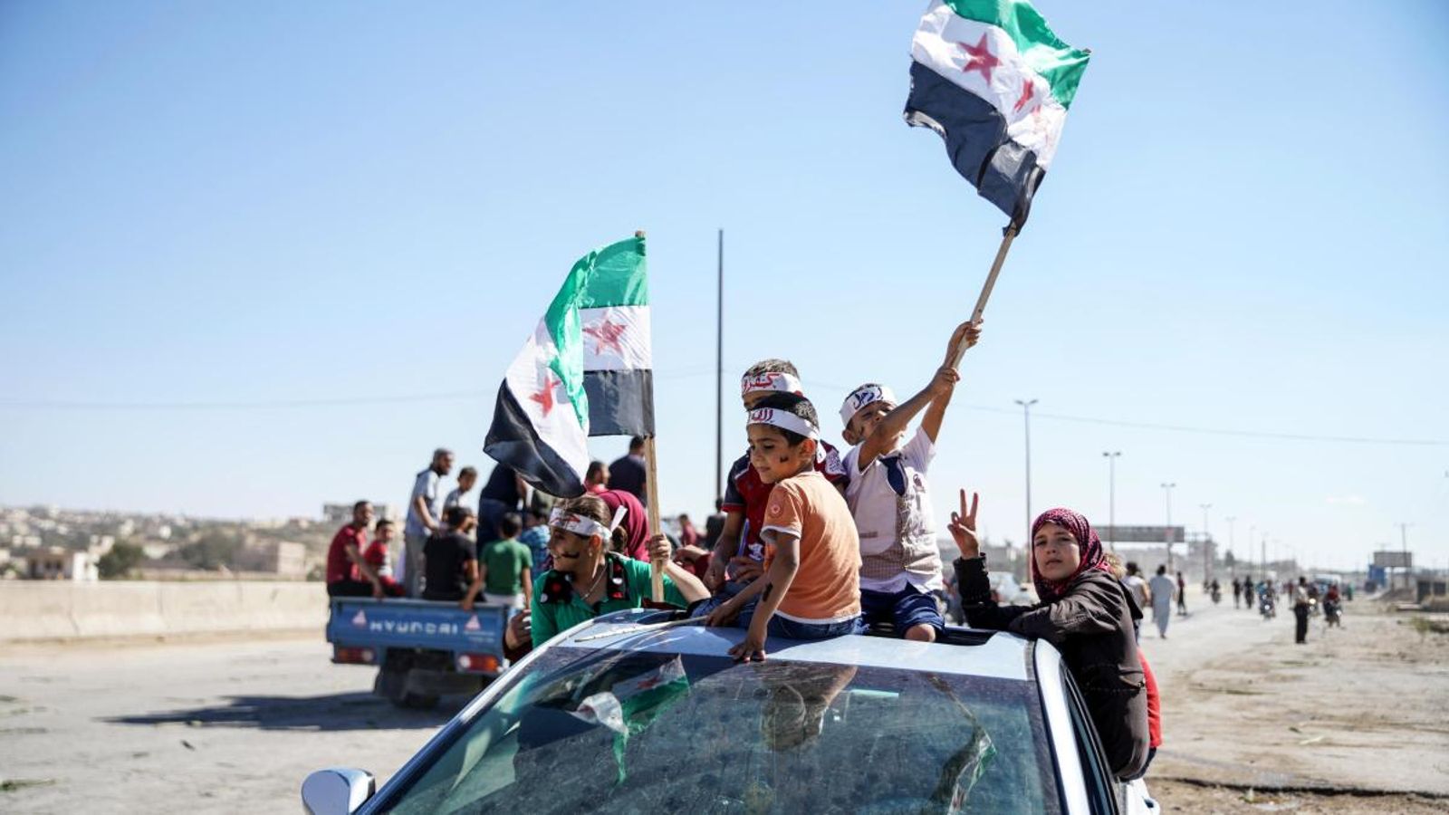 Persones que donen suport a les forces revolucionàries durant una protesta recent a la província d'Idlib