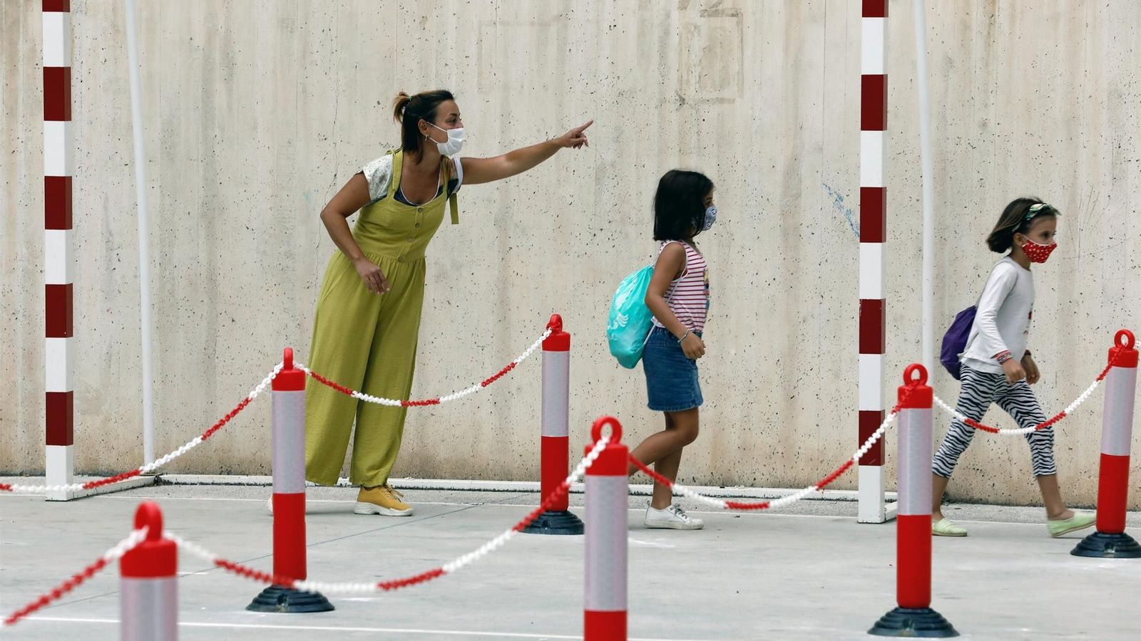 Una mestra ordena una cua d'alumnes