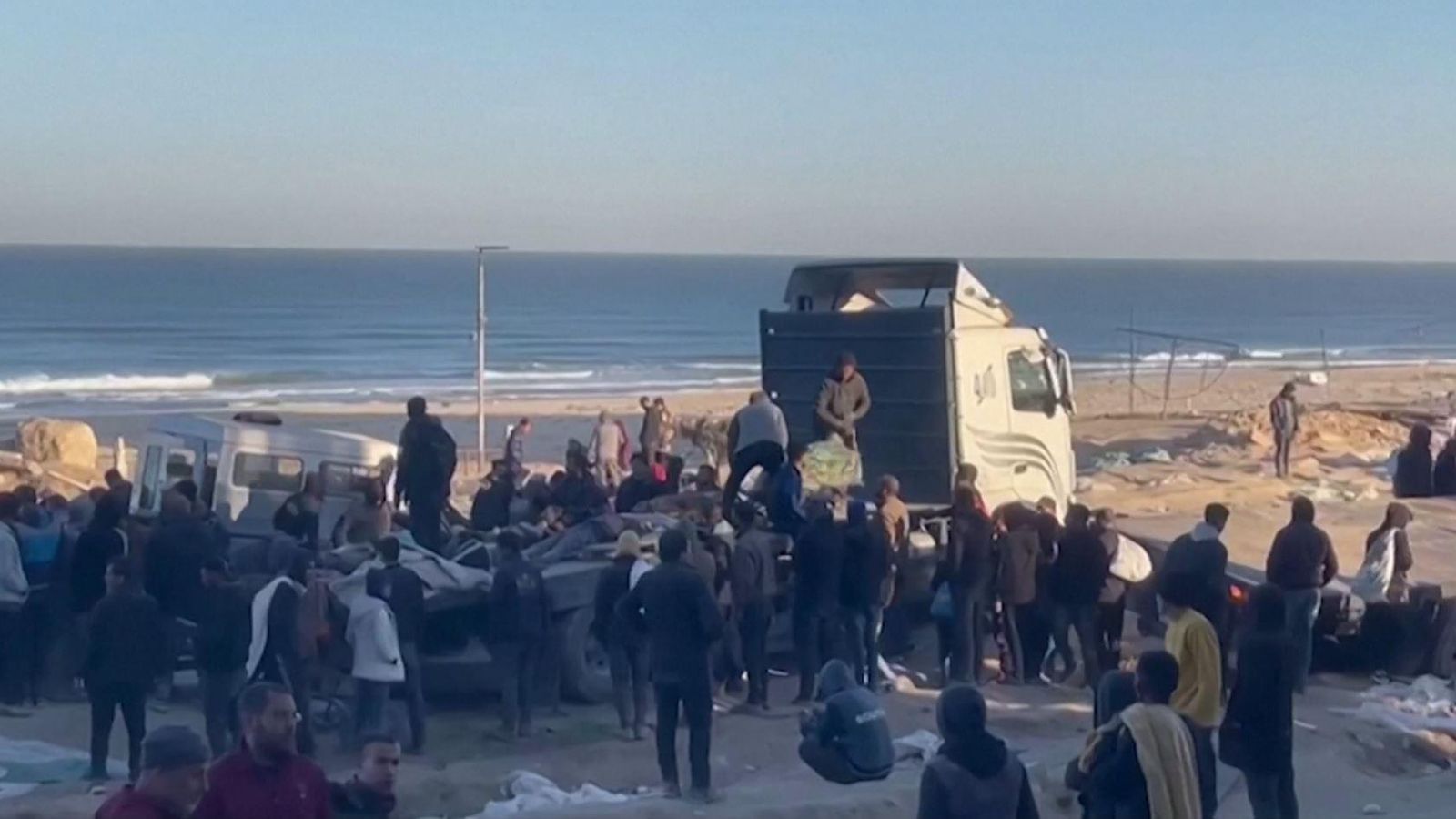 Palestins carreguen els morts a un dels camions d'ajuda Palestins carreguen els morts a un dels camions d'ajuda