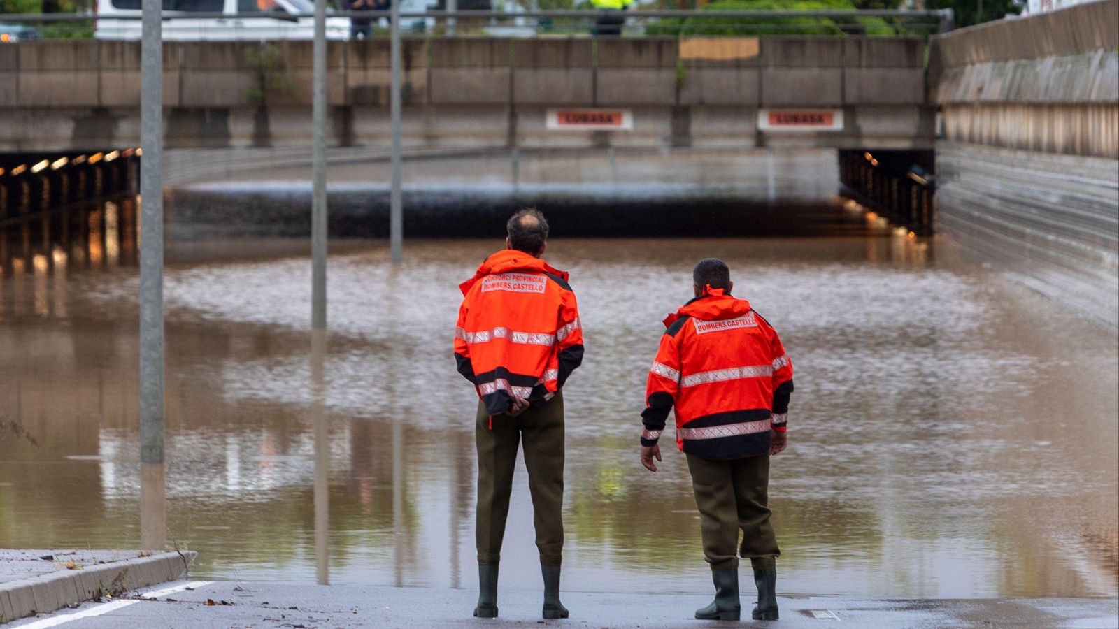 Dos bombers observen un túnel de Benicàssim, inundat per les pluges caigudes aquesta matinada